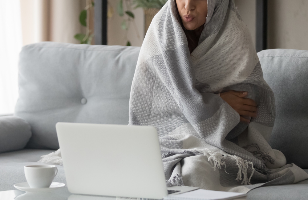 部屋で寒がる女性　冬