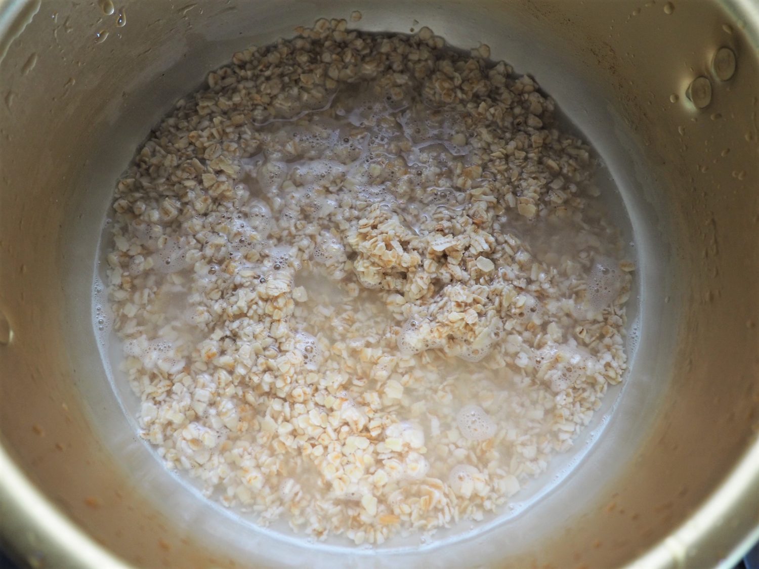 （1）鍋にオートミールと水（豆乳）を入れ、弱火で煮る