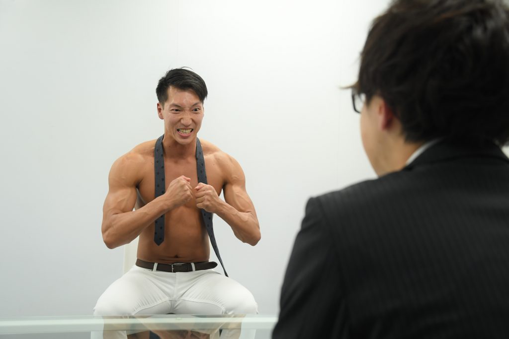 「圧迫面接を受けるマッチョ」