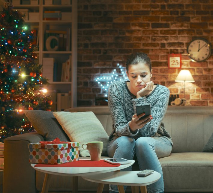 Sad lonely woman chatting on Christmas Eve