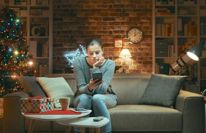 Sad lonely woman chatting on Christmas Eve